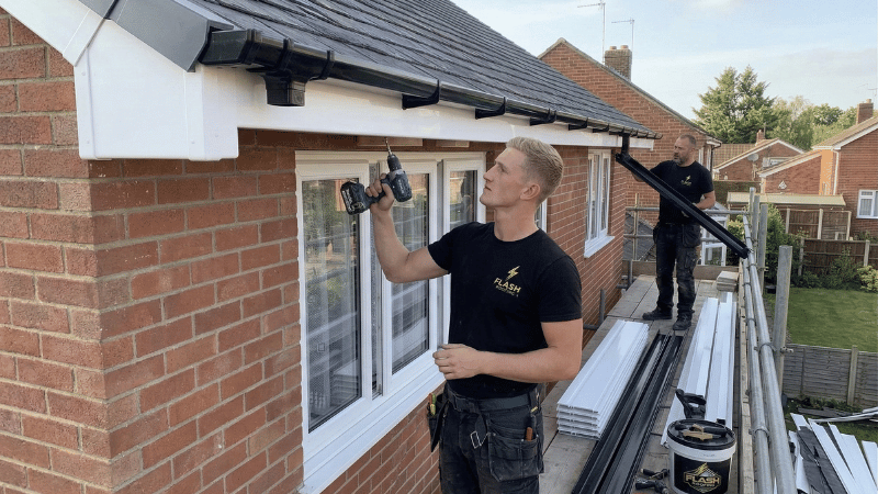 Flash Roofing engineers installing fascias and guttering on residential property