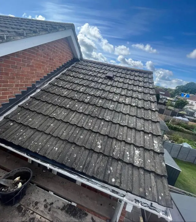 Old moss covered roof tiles before replacement