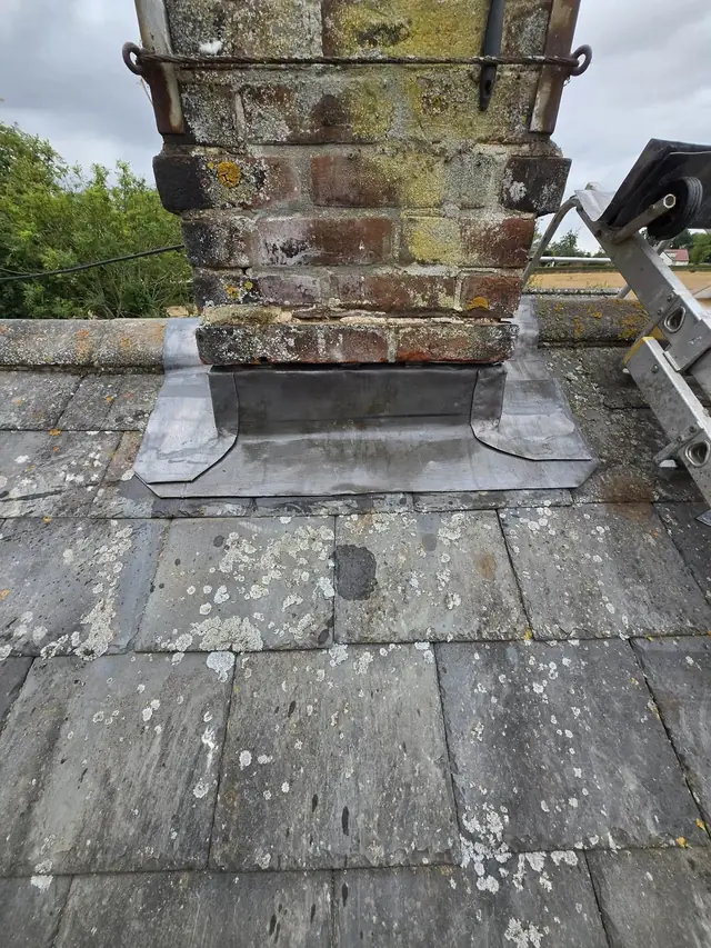 Chimney stack and lead flashing on an older slate roof