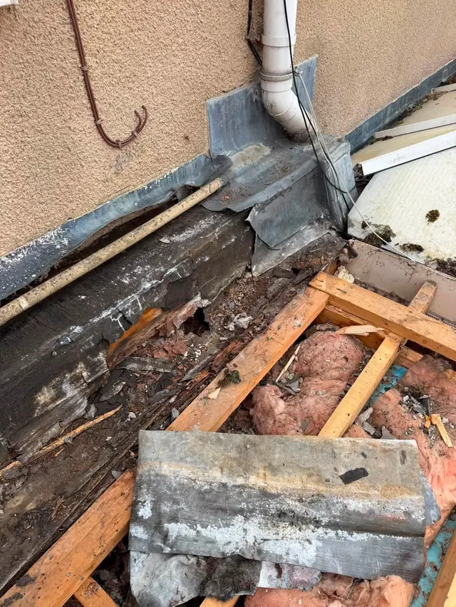 Lead valley and flashing detail exposed during a roof repair