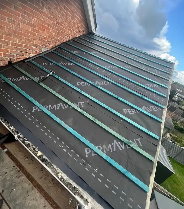 Branded breathable roofing membrane and battens laid up to a brick chimney