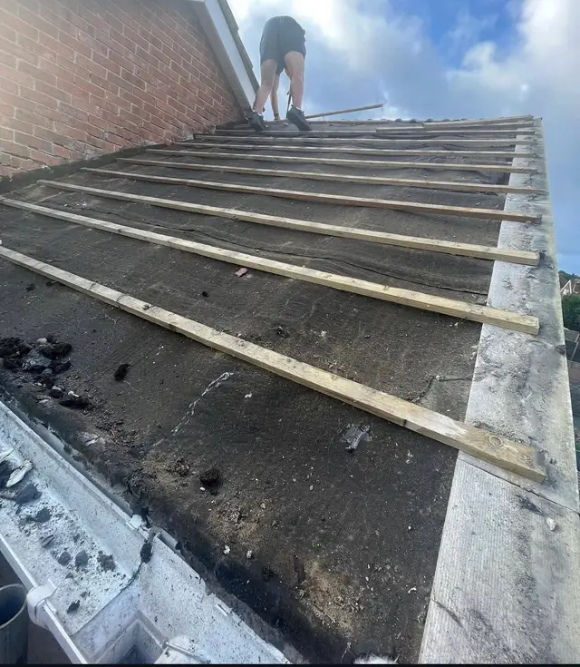 New membrane and battens running from the ridge down to a chimney