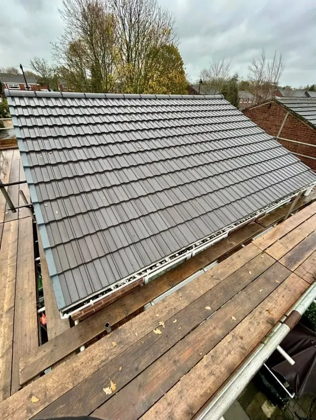 Wide view of a completed dark tiled pitched roof
