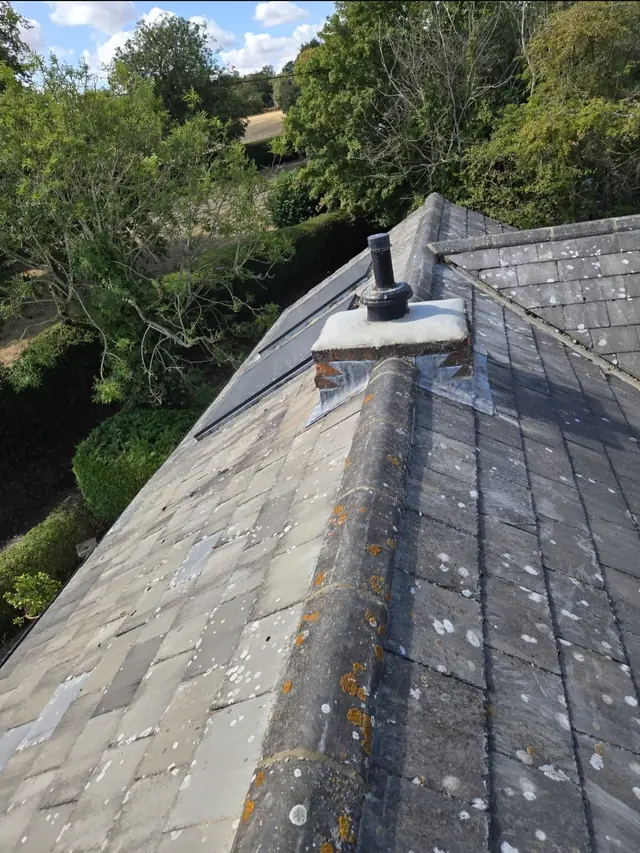 Roof ridge and chimney with neighbouring rooftops behind